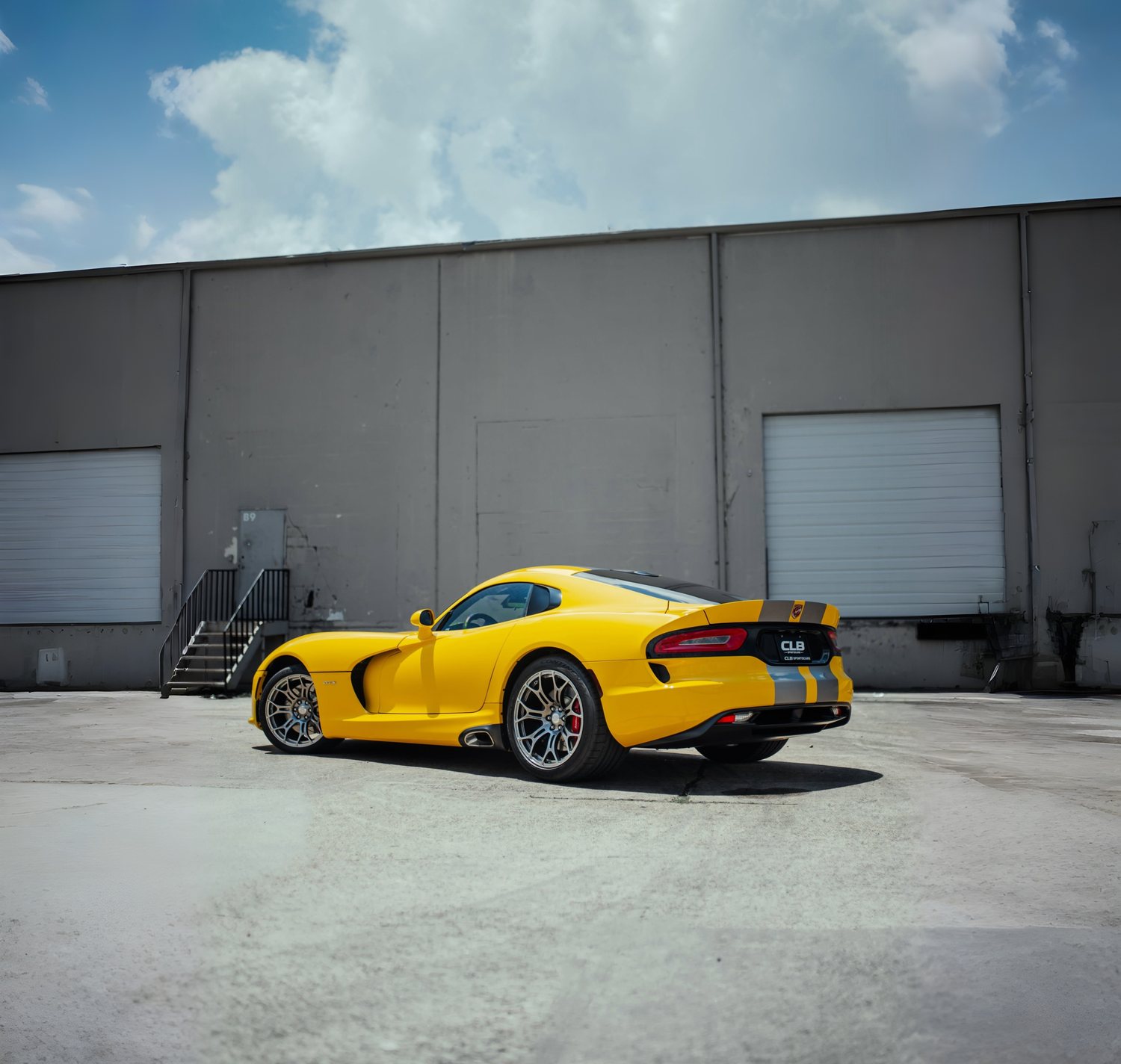 Yellow Dodge Viper parked at a warehouse