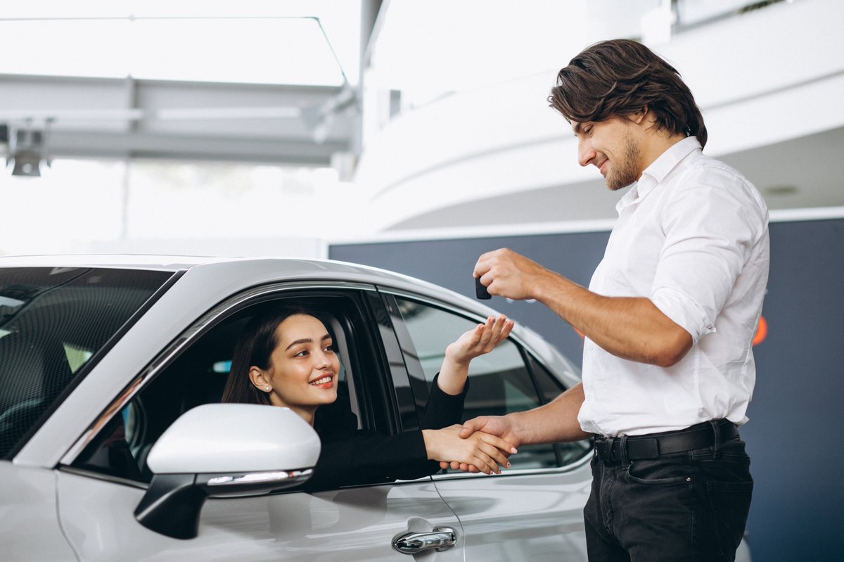 Seller handing over car keys